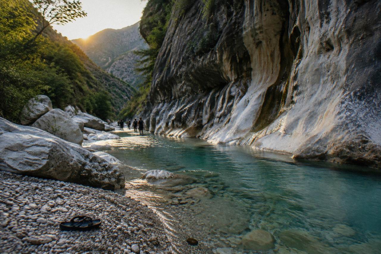 Narrow limestone canyon in the Sierra de Santiago with clear turquoise water flowing between dark rock walls