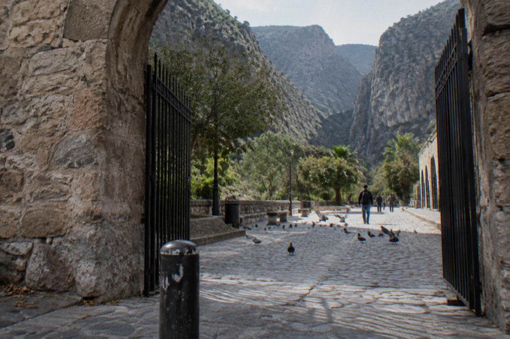 Old stone gate and colonial archway on a city street in Monterrey