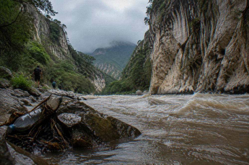 Swift brown river rushing between canyon walls after rain