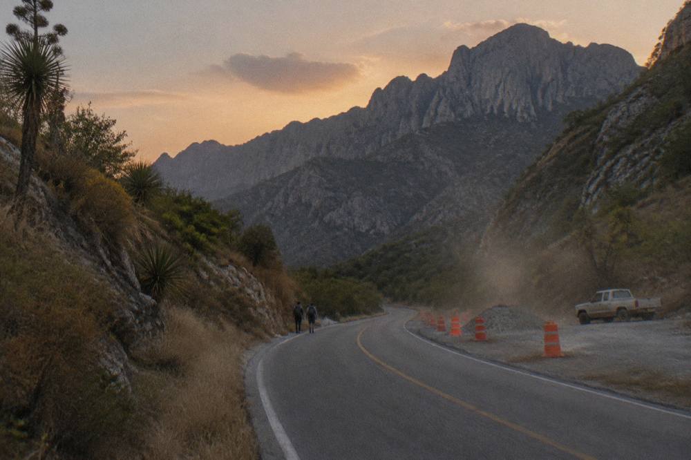 Carretera Nacional curving between dry hills with the Sierra de Santiago ahead