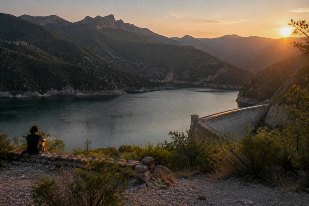 View over a reservoir and forested mountains near Santiago at golden hour